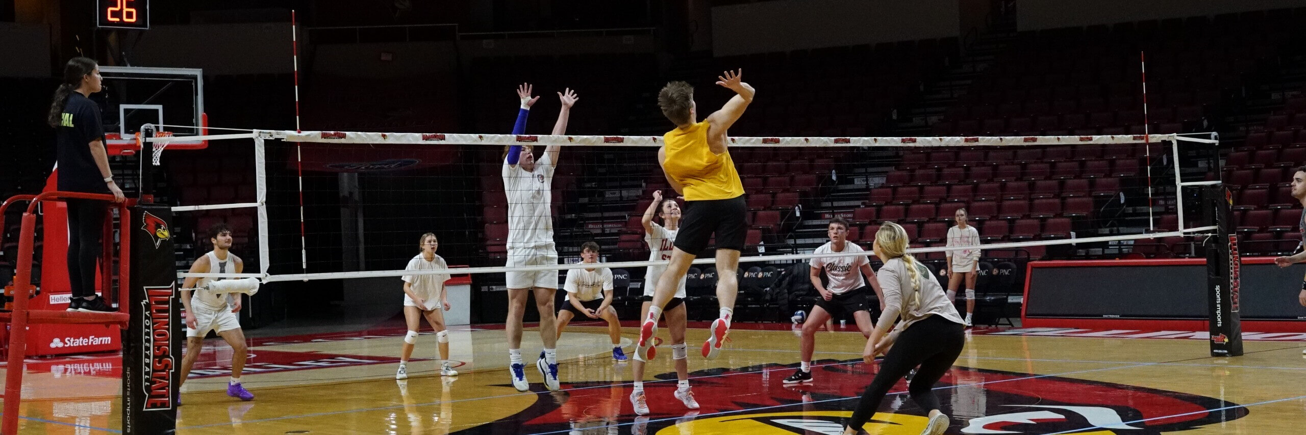 Students play co-ed volleyball.