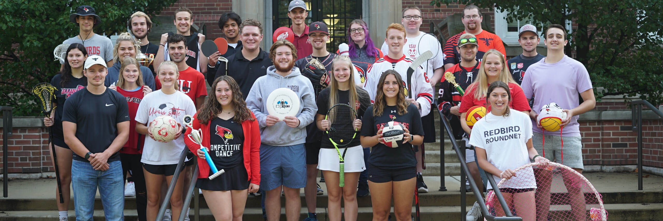 Sport Clubs students pose holding the equipment representing their sport.